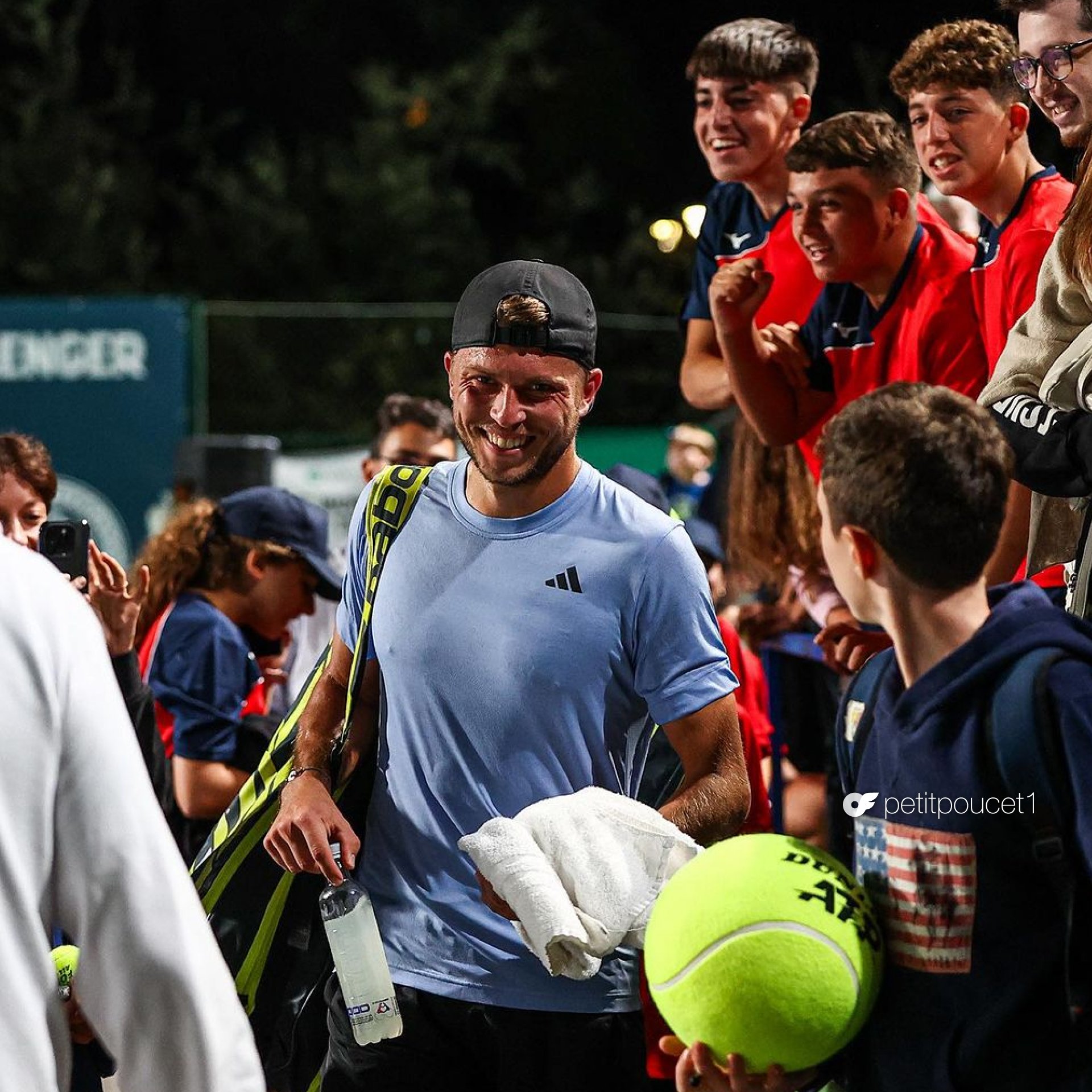 Muller2_AllScreenSizes_1920x1920 Alex Müller walking past fans, smiling