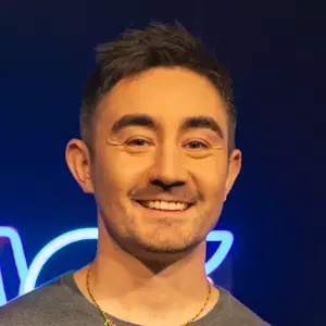 Comedian DJ Rybski poses in front of the LMAOF logo