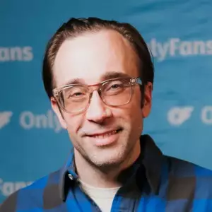 Comedian Jim Tews poses in front of the LMAOF logo