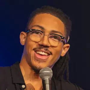 Comedian Jason Ellis performs on stage.
