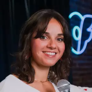 Comedian Leyla Ingalls poses in front of the LMAOF logo