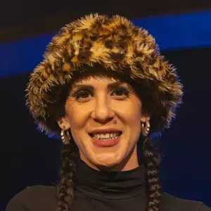 Comedian Marcella Arguello poses in front of the LMAOF logo