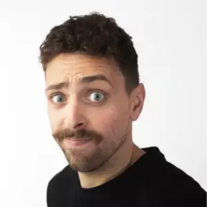 Comedian Martin Graham smirks at the camera.
