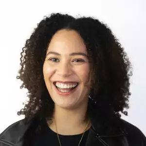 Comedian Mary O'Connell smiles at the camera.