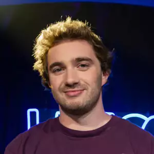 Comedian Evan Hull poses in front of the LMAOF logo
