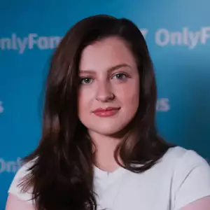 Comedian Freya Mallard poses in front of the LMAOF logo