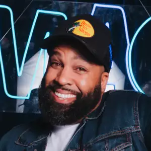 G. King poses in front of the OnlyFans logo.