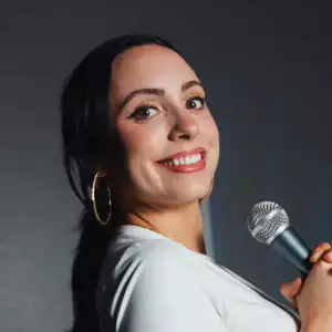 Comedian Harper-Rose Drummond poses in front of the LMAOF logo