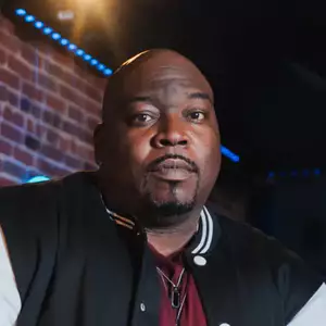 Comedian Jay Washington poses in front of the LMAOF logo
