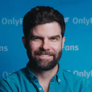 Jono Zalay poses in front of the OnlyFans backdrop.