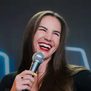 Comedian Mandy Martino performing stand-up comedy on stage at LMAOF