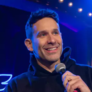 Comedian Mike Glazer performing stand-up comedy on stage at LMAOF