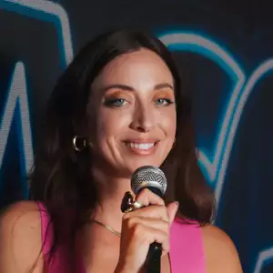 Comedian Monarey Martinez poses in front of the LMAOF logo
