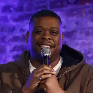 Comedian Napoleon Emill performing stand-up comedy on stage at LMAOF