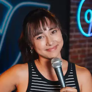 Comedian Natasha Collier poses in front of the LMAOF logo