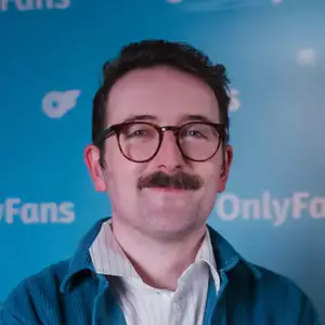 Comedian Sam Lake poses in front of the LMAOF logo