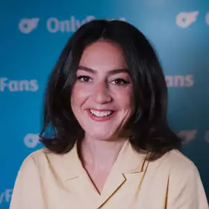 Comedian Tamsyn Kelly poses in front of the LMAOF logo
