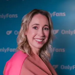 Comedian Tiff Stevenson poses in front of the LMAOF logo