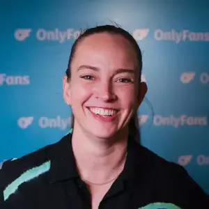 Comedian Zoe Coombs Marr poses in front of the LMAOF logo