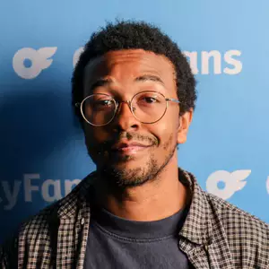 Comedian Myles Johnson poses in front of the LMAOF logo.