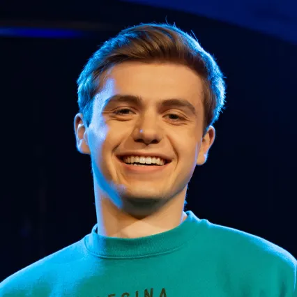 AJLeidig Comedian AJ Leidig poses on stage at LMAOF