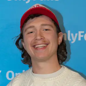 Comedian Carter Dockerty poses in front of the LMAOF logo