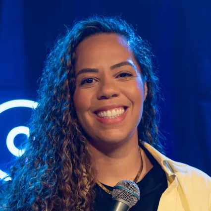 ChloeMikala Comedian Chloe Mikala poses on stage at LMAOF
