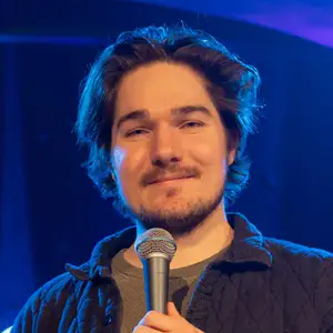 Comedian Steven Haas poses on stage at LMAOF