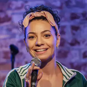 Comedian Liz Miele performing on stage at LMAOF: New York.
