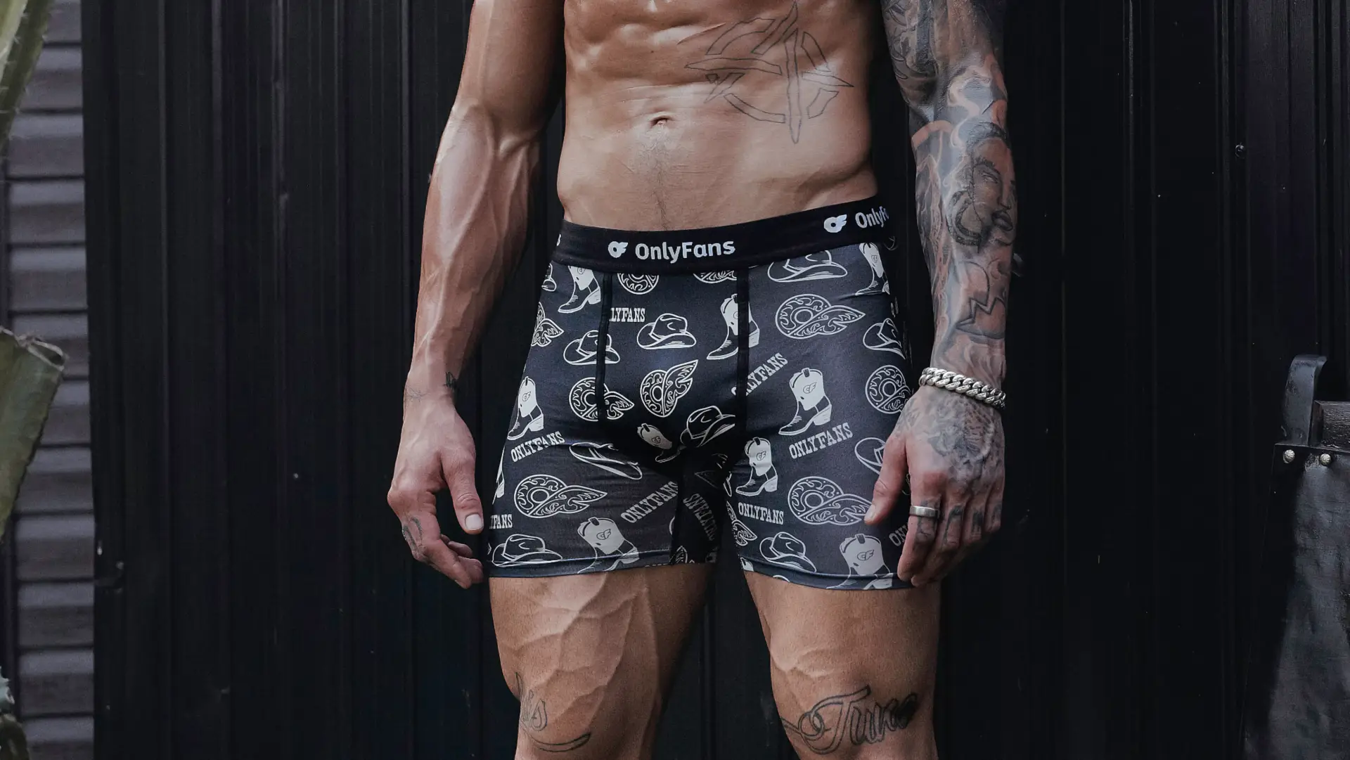 A male model poses in the Men's Boxer Brief - Western, which matches the Women's lounge set perfectly