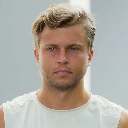 Alex_Muller Alex Müller, tennis player, looks off camera in his white tank top.