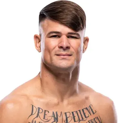 Diego Lopes, MMA fighter, smirks to camera in a tight close-up shot of his face.