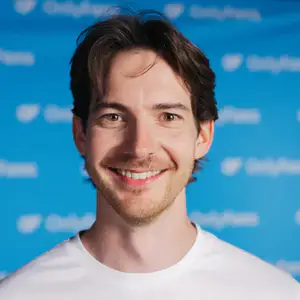 Joseph Parsons poses before an OnlyFans-branded step and repeat blue wall.