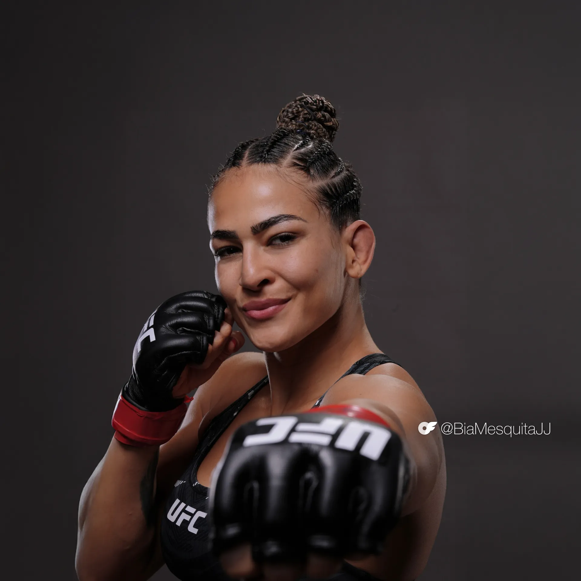UFC athlete Bia Mesquita poses to camera with gloves on