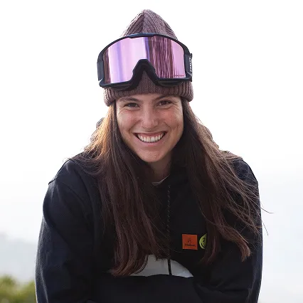 Professional snowboarder Maria Hidalgo Perlas smiling outdoors in a beanie and ski goggles.