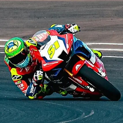 Eric Granado Eric Granado, professional motorcycle racer, leans on a turn during a motorcycle race.