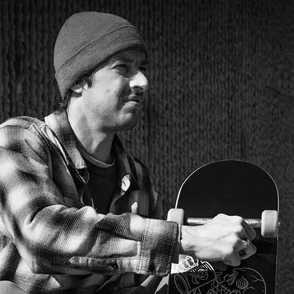 Ryan Decenzo, Canadian professional skateboarder and six-time X Games medalist, holding a skateboard.