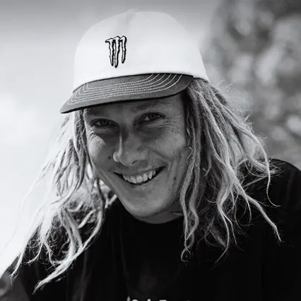 Boyd Hilder Boyd Hilder, professional BMX biker, smiles to camera in a white Monster baseball cap.