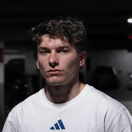 BMX rider Eddy Clerté wearing a white Adidas T-shirt in a close-up portrait.